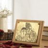 Personalized 3x4 inch brass photo table frame featuring a grandfather and grandson, mounted on a wooden base.